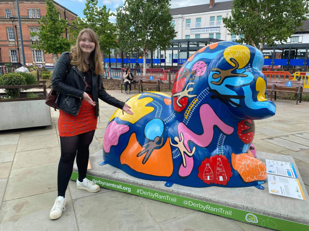 Holly Aspinall poses next to the Derby Community Ram at the Darby Ram Trail