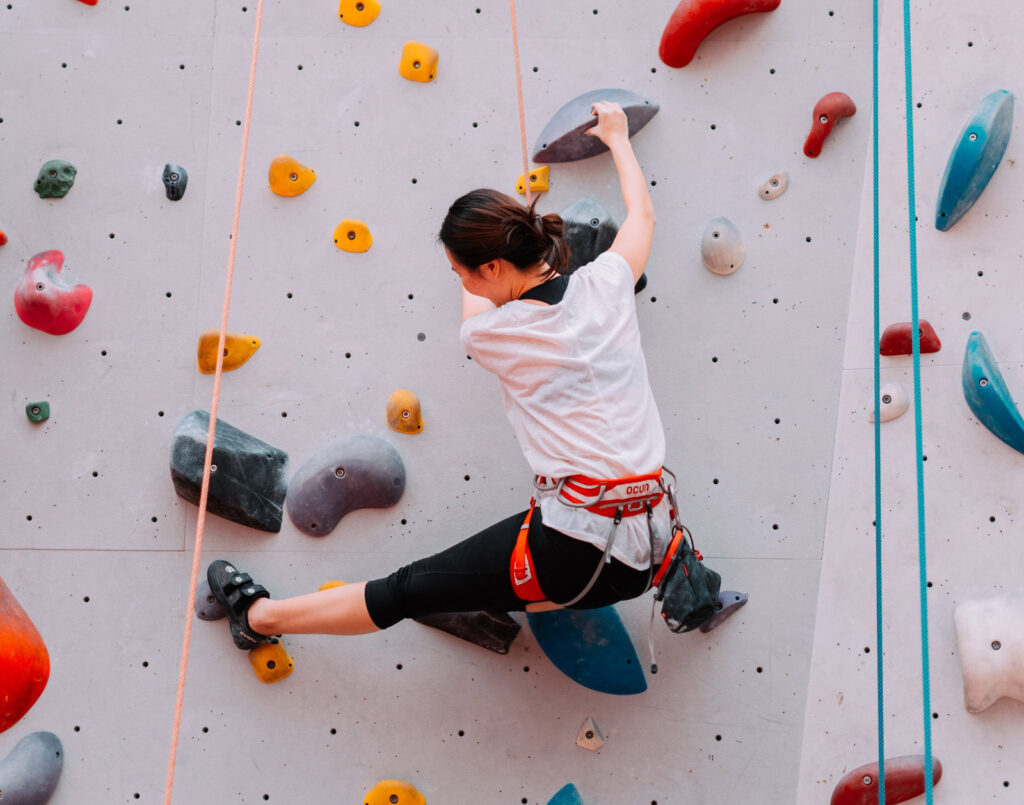 A climber scales an indoor climbing wall