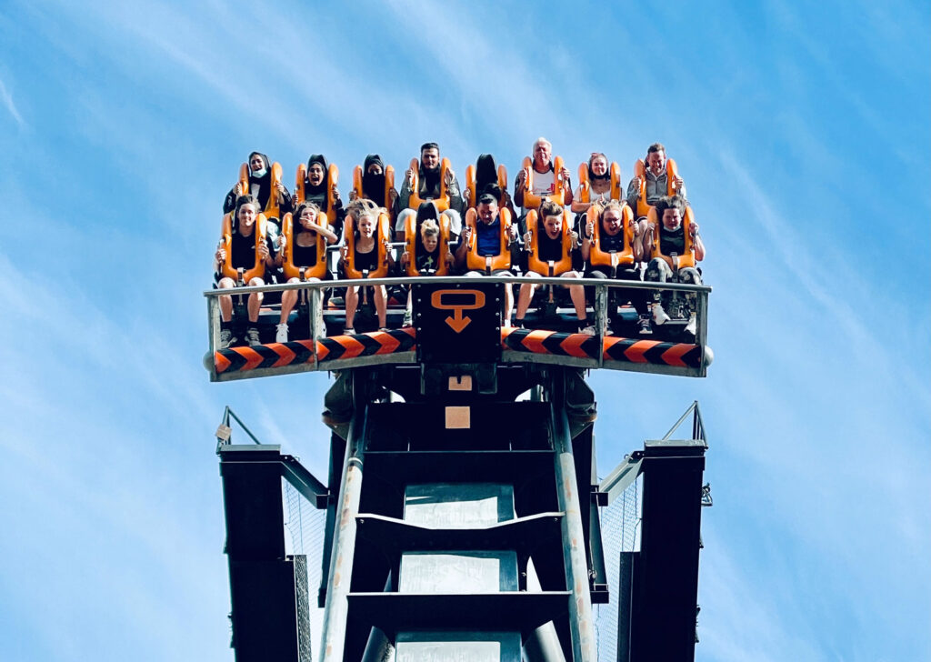 People riding an Alton Towers rollercoaster, screaming and laughing