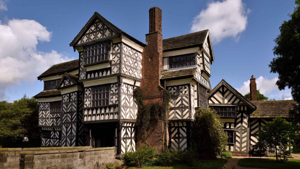 Ani mage of the exterior of Little Moreton Hall - an ornate white building clad with black beams.