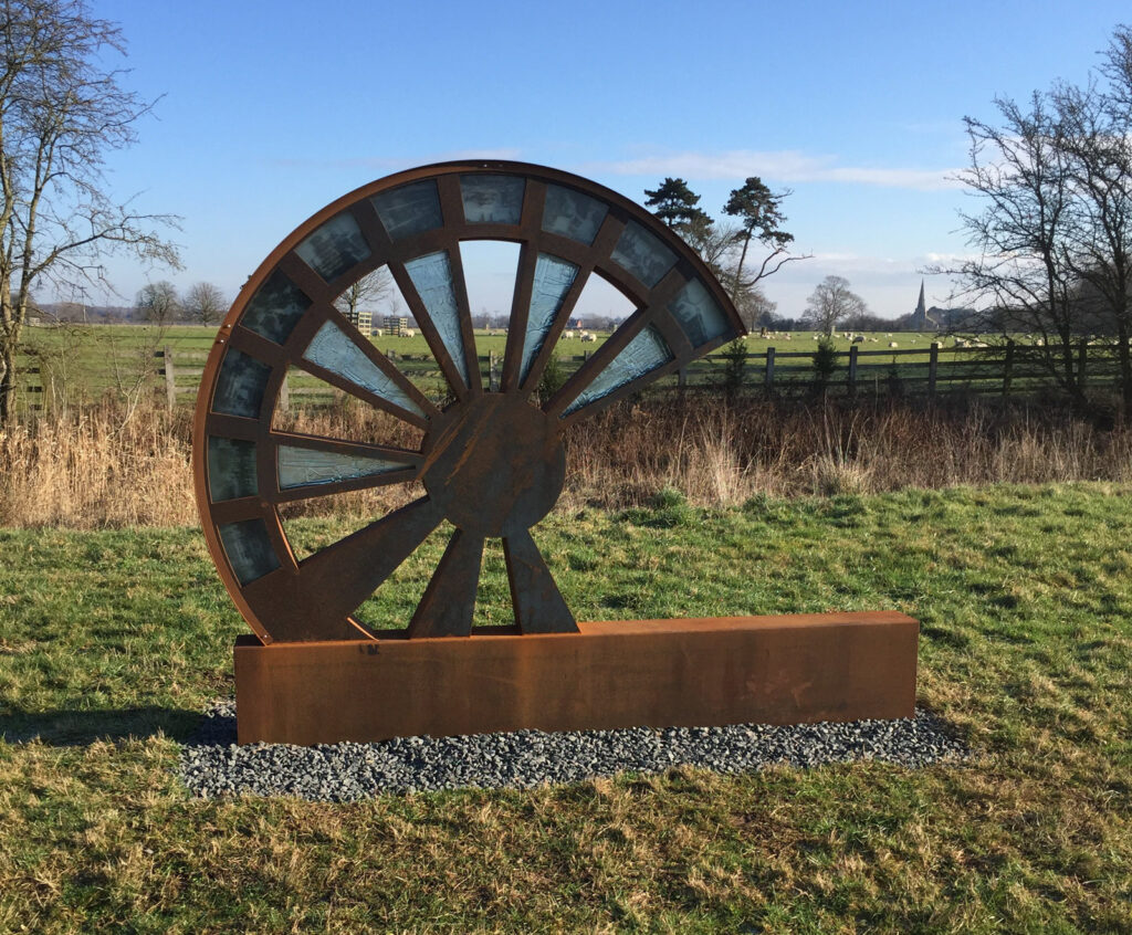 An image of the pit wheel - a metal wheel sculpture on the Salt Brook Heritage Trail