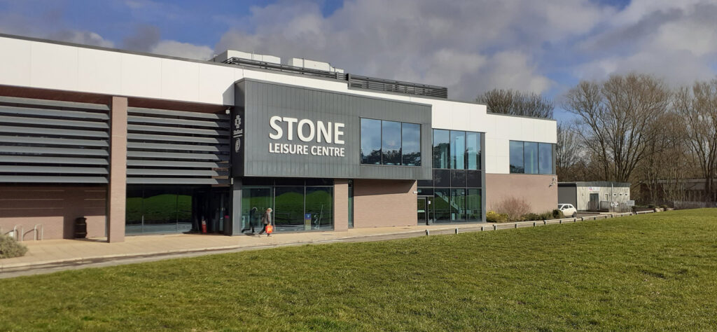 The exterior of Stone Leisure Centre - a modern building clad with wood and glass.