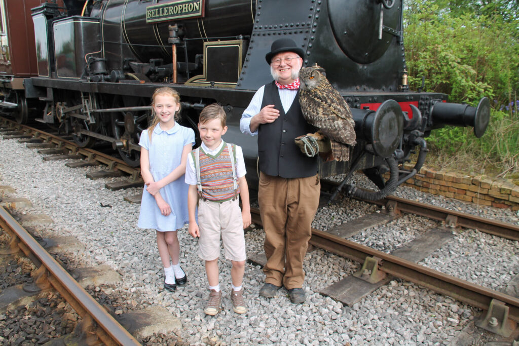 Children meet an owl near a steam locomotive at Foxfield Railway
