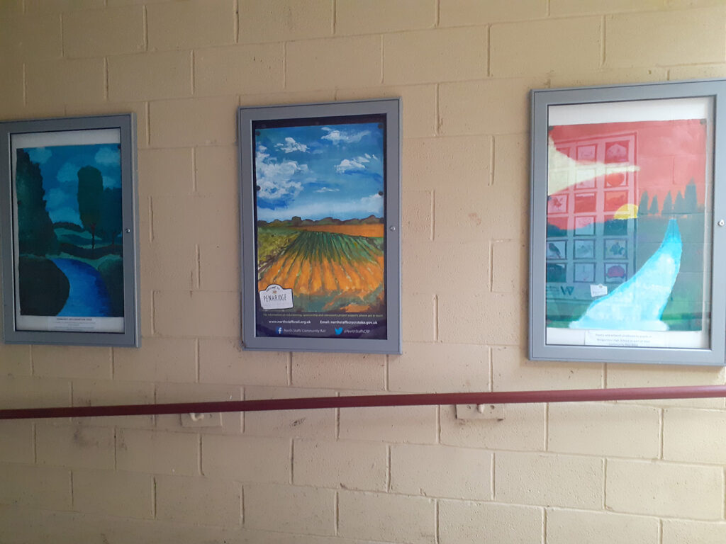 Picture of the display cases at Penkridge Station. Artwork from the local community is displayed in the cases.