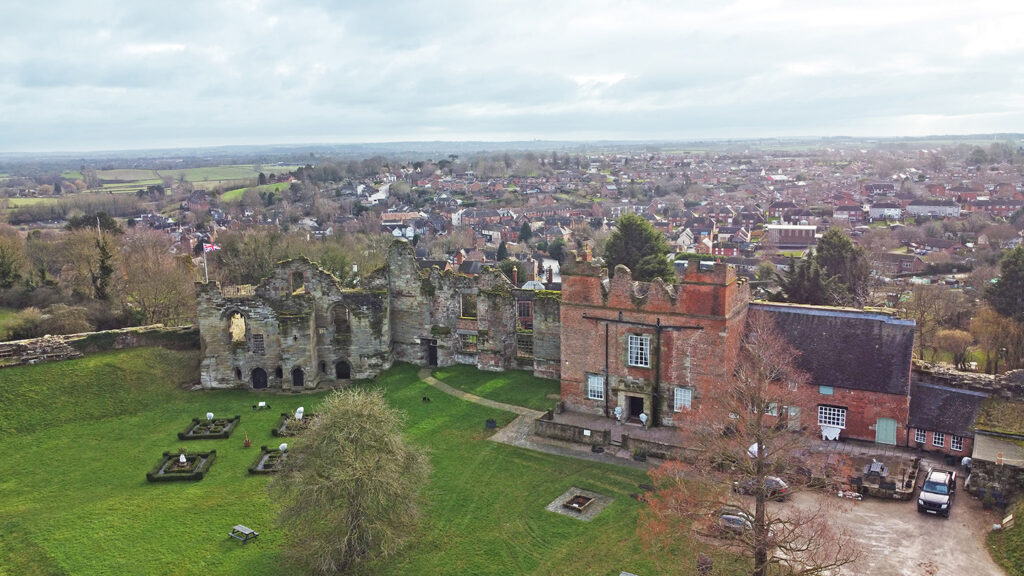 Aerial shot of Tutbury Castle. The front of the castle can be seen with Tutbury in the background