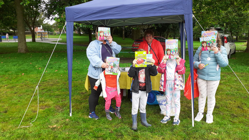An anonymous group of festival goers receiving free books